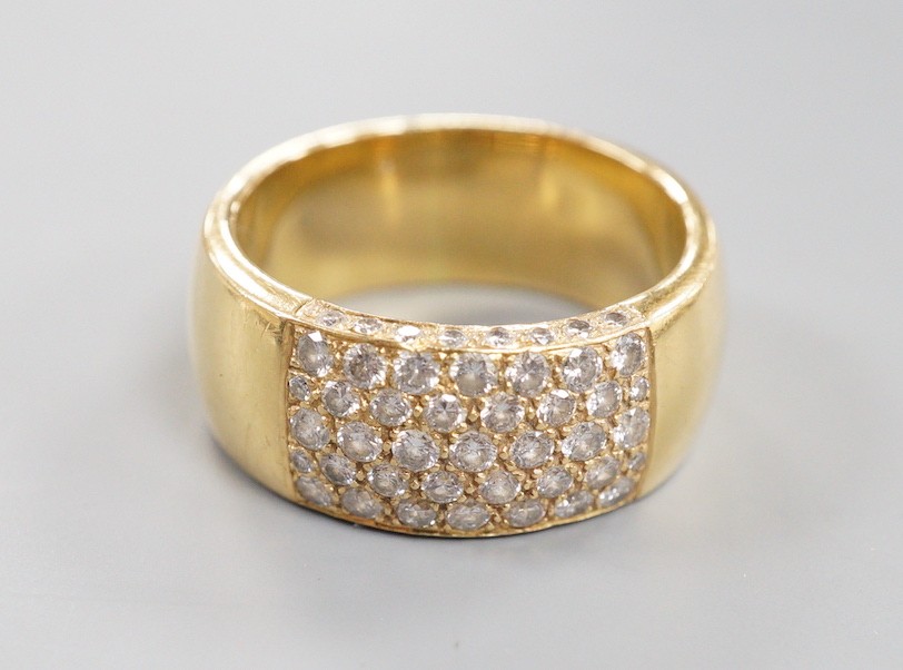 A modern yellow metal (tests as 18ct) and part pave set diamond ring, size R/S gross weight 13.4 grams.